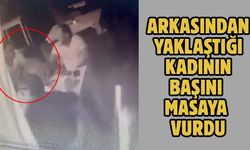 Arkasından yaklaştığı kadının başını masaya vurdu